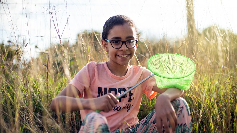 Winchester Science Centre Boom and Bloom girl in field with net