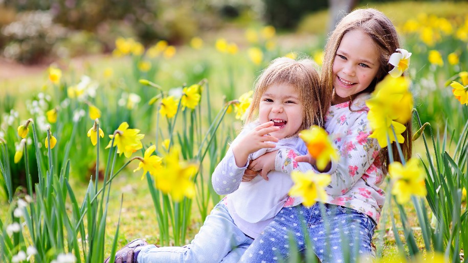 West Horsley Place Easter Children sitting among the daffodils