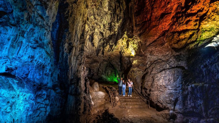 A family exploring Wookey Hole Caves in Somerset.