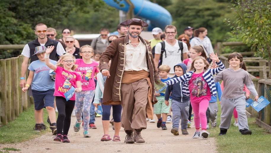 Pirate Captain Starling with a group of visitors to Hatton Adventure World in Warwickshire during the May half term Pirate Invasion event.