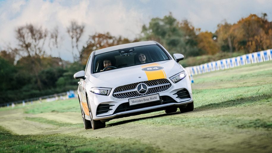 Mercedes-Benz Car driving in a field at Mercedes-Benz World