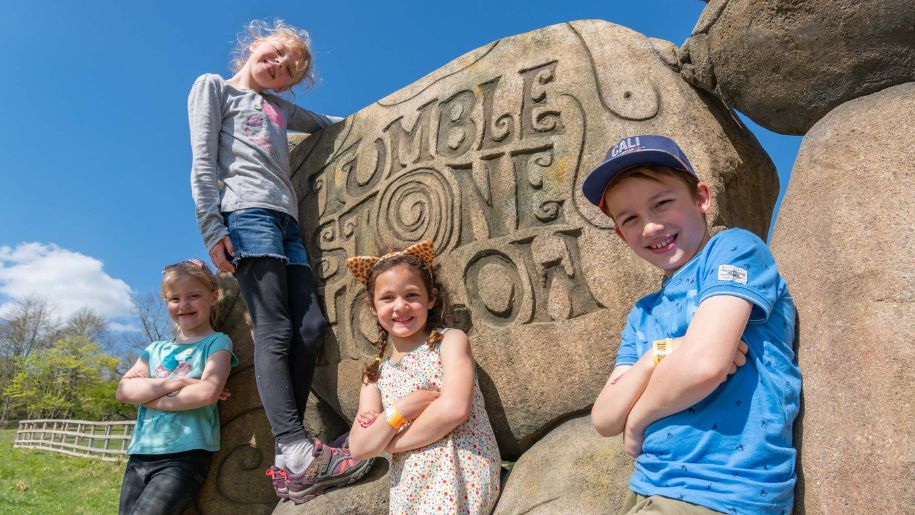 Kids posing with an engraved tumblestone hollow rock