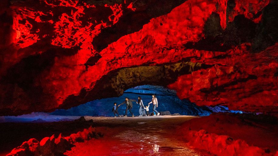 Family walking through the caves at Wookey Hole