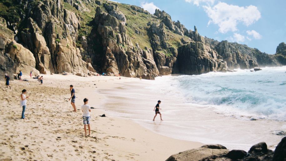 Families playing on a beach in Cornwall