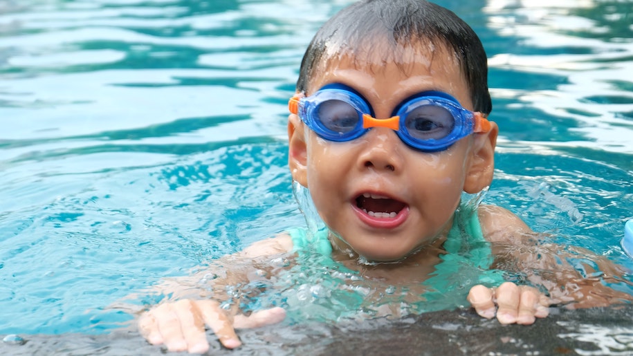 Boy swimming wearing goggles