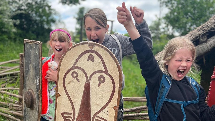 3 children playing dress up at Chiltern Open Air Museum