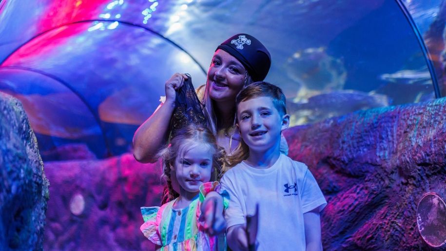 Two children with a pirate at sea life