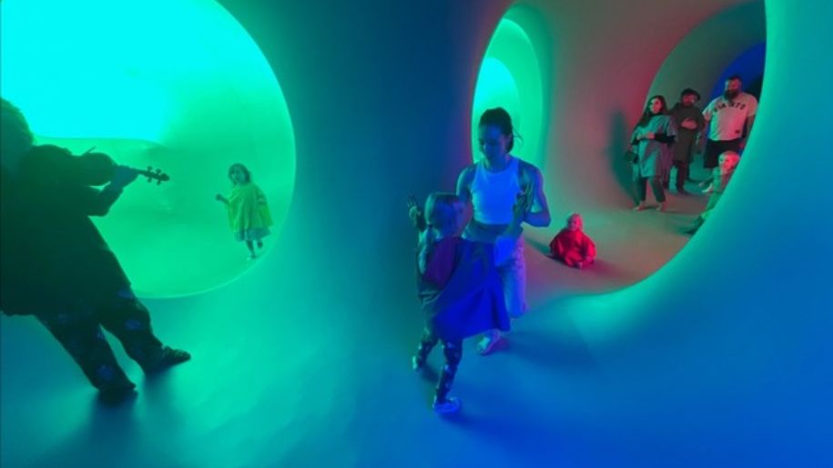 Colourful abstract tent with children dancing inside