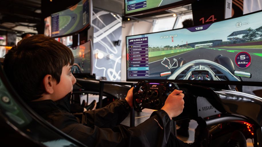 Young boy on a racing simulator at F1 Arcade