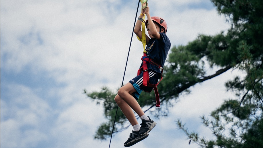 A child on a zip line.