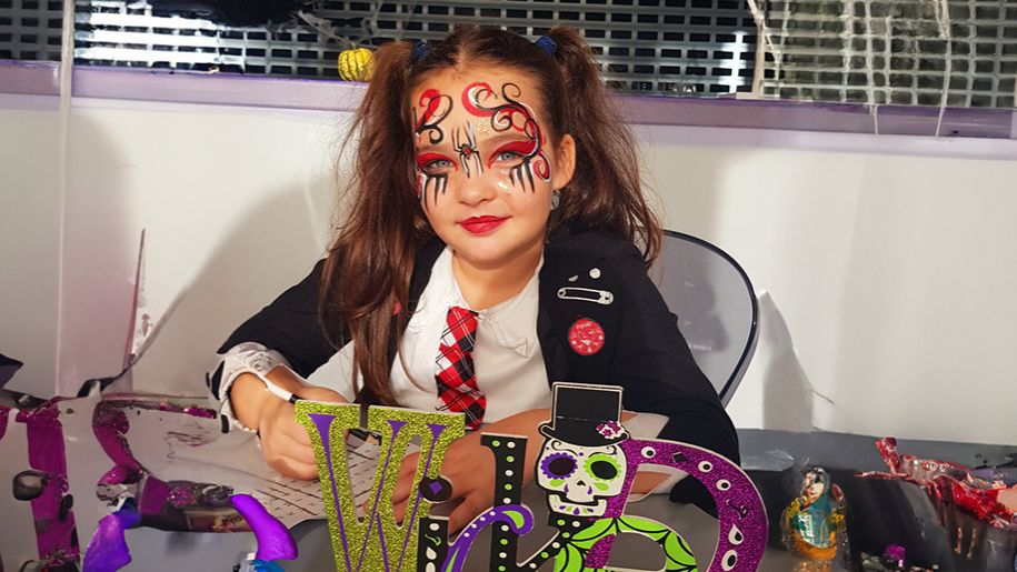 Girl smiling with Halloween themed face paint
