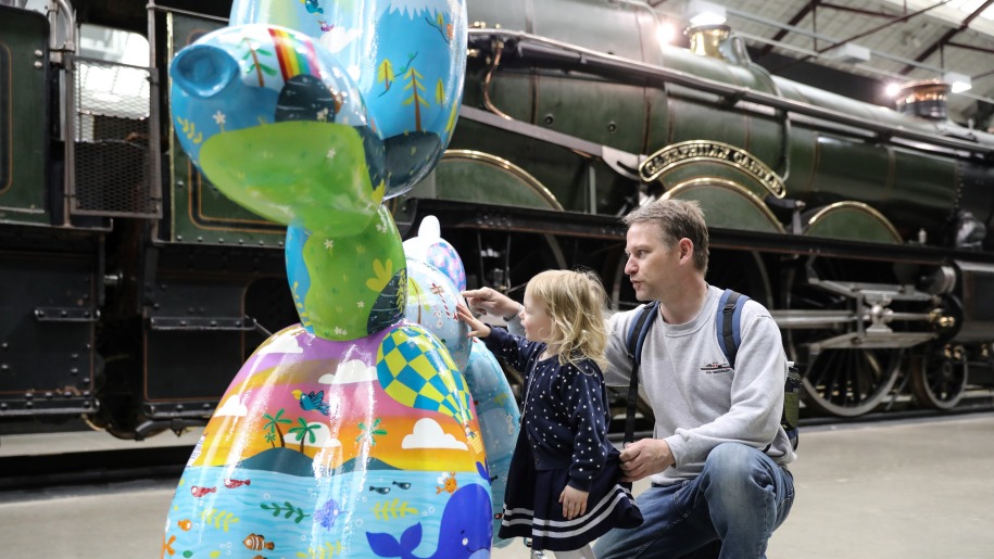 A family meeting a balloon dog sculpture.