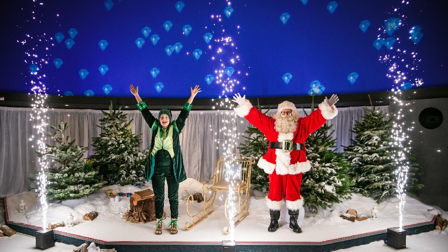 Winchester Science Centre Cosmic Christmas Elf and Father Christmas with out-stretched arms
