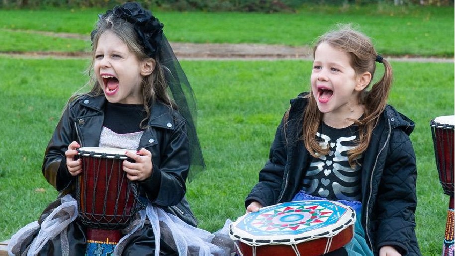 Celtic Harmony Camp Samhain two girls drumming in Halloween costume