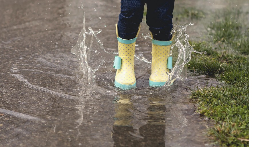 Generic Wellies on little girl splashing in puddles
