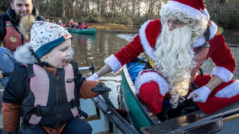 New Forest Activities Santa in a boat with a small child