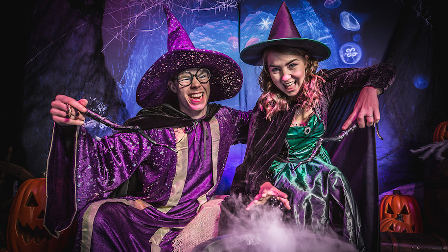 Boy and Girl witches with wands at Sea Life for Halloween