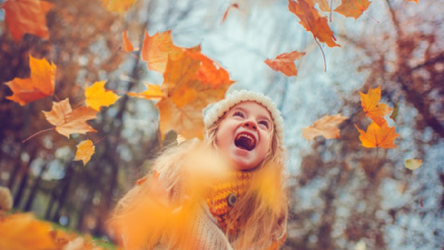 West Horsley Place Girl in amongst the Autumn leaves