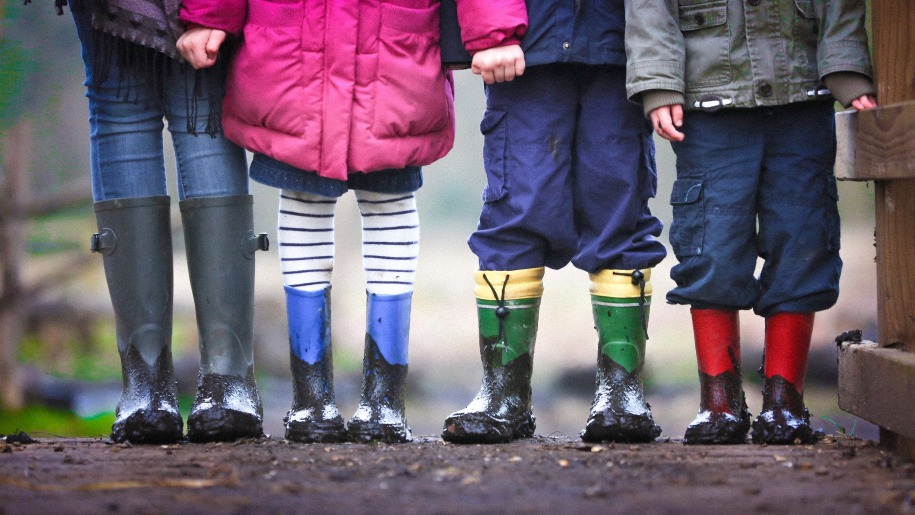 Children in winter coats and muddy wellies.