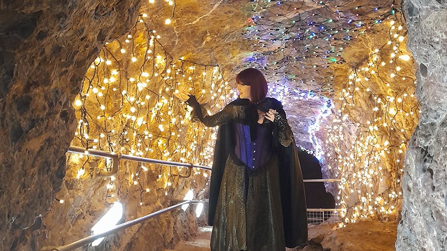 A witch in the illuminates caves at Wookey Hole