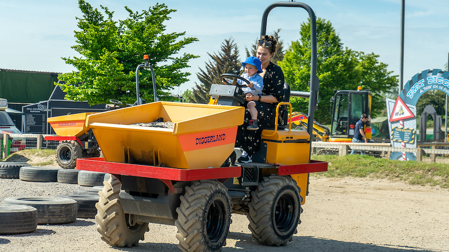 Mum and toddler on dumper truck at Diggerland