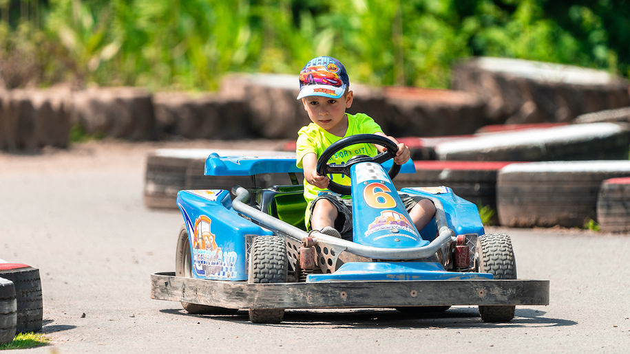 Small boy on blue go-kart at Diggerland