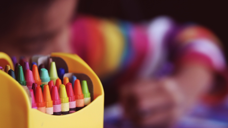 Crayons in a yellow container.