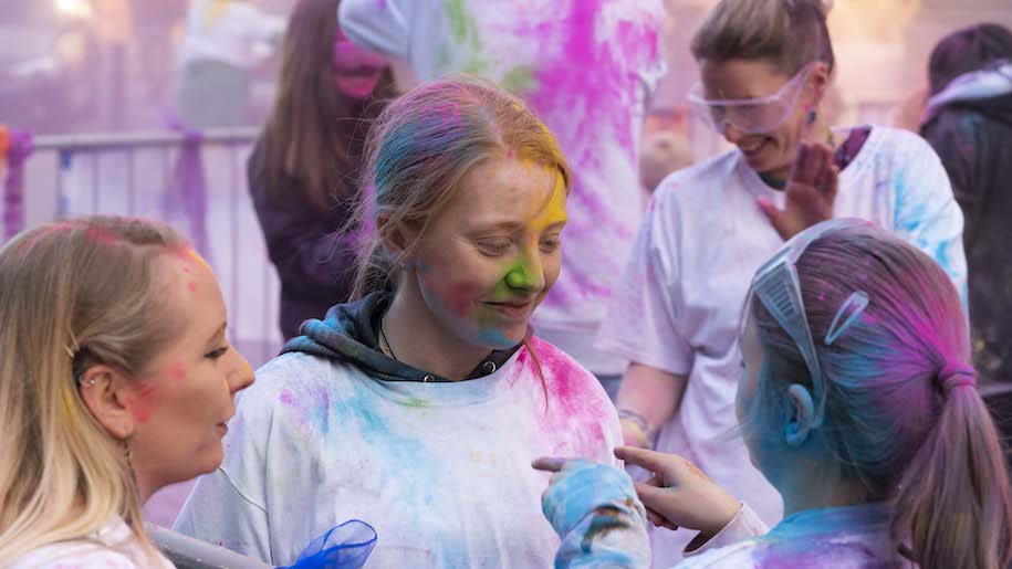 Girls covered in coloured paint at Barrow Colour Festival