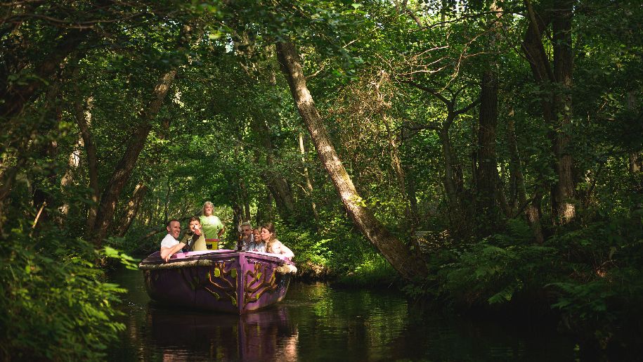 BeWILDerwood Norfolk boat with family on the lazy river