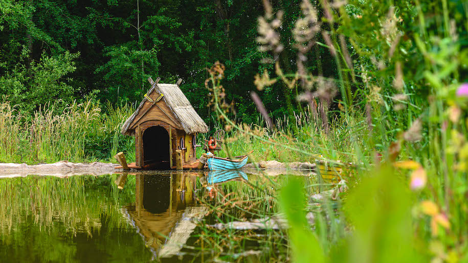Mini boat house and blue boat at BeWILDerwood Cheshire
