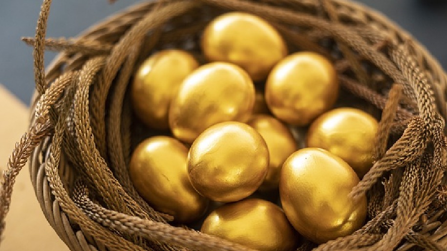 Generic golden eggs in a nest made of basket and twigs