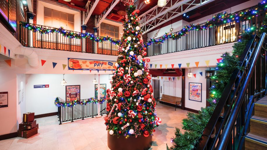 christmas tree in make believe train station concourse