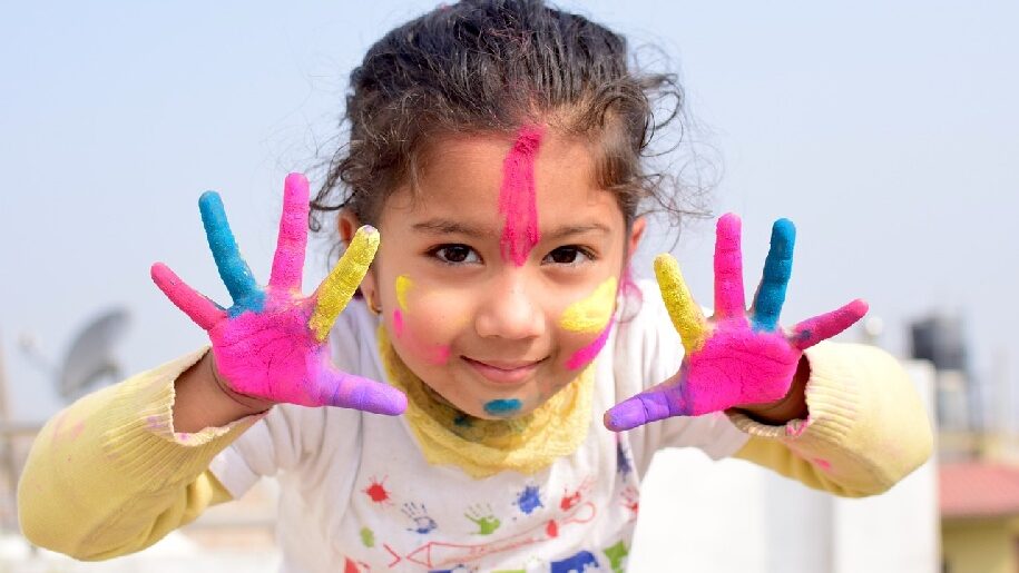Generic Young Girl painting with both hands covered in paint
