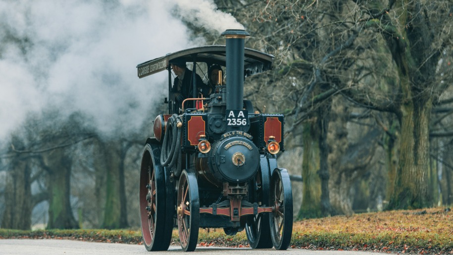 Steam traction engine travelling along a road.