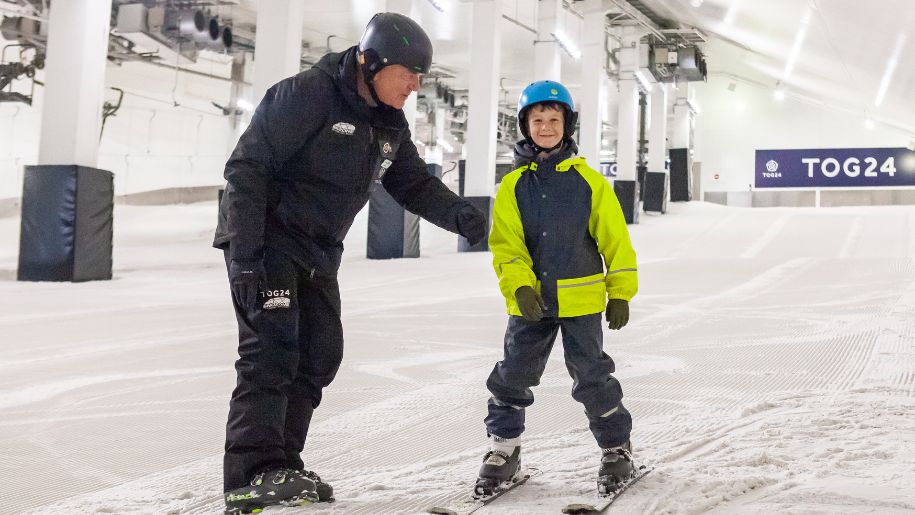 An instructor and child on the slopes at Snozone