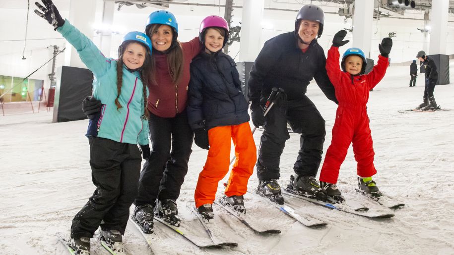 Family of 5 in ski wear on indoor ski slopes at Snozone