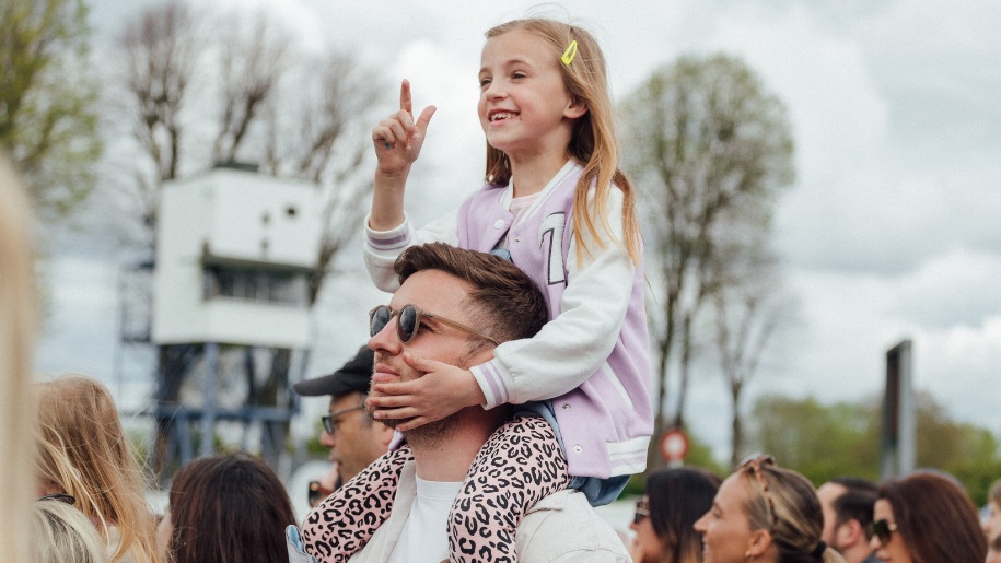A child on an adult's shoulders at Royal Windsor.