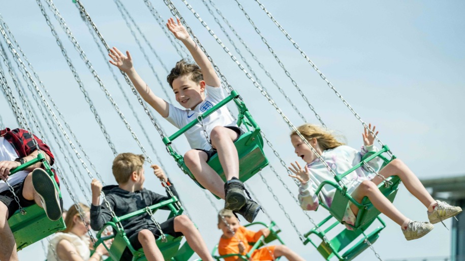 Children on fairground ride at Windsor Racecourse.