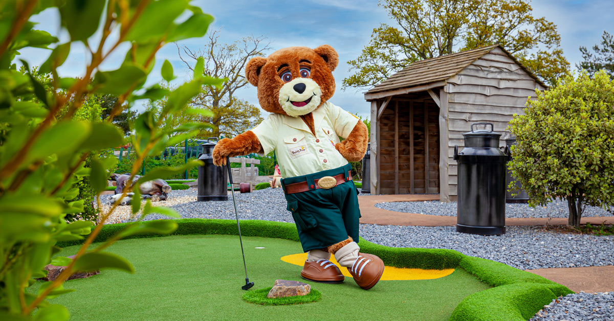 man dressed as bear playing golf
