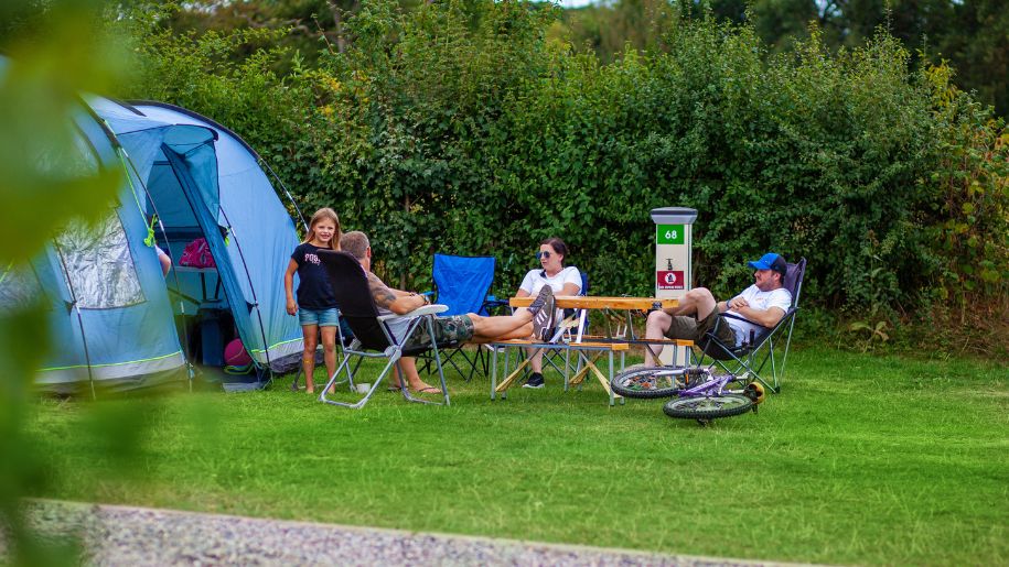 Family in deck chairs camping at Crealy