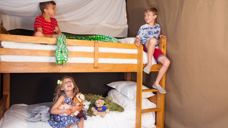 Three children playing on bunk beds at Crealy