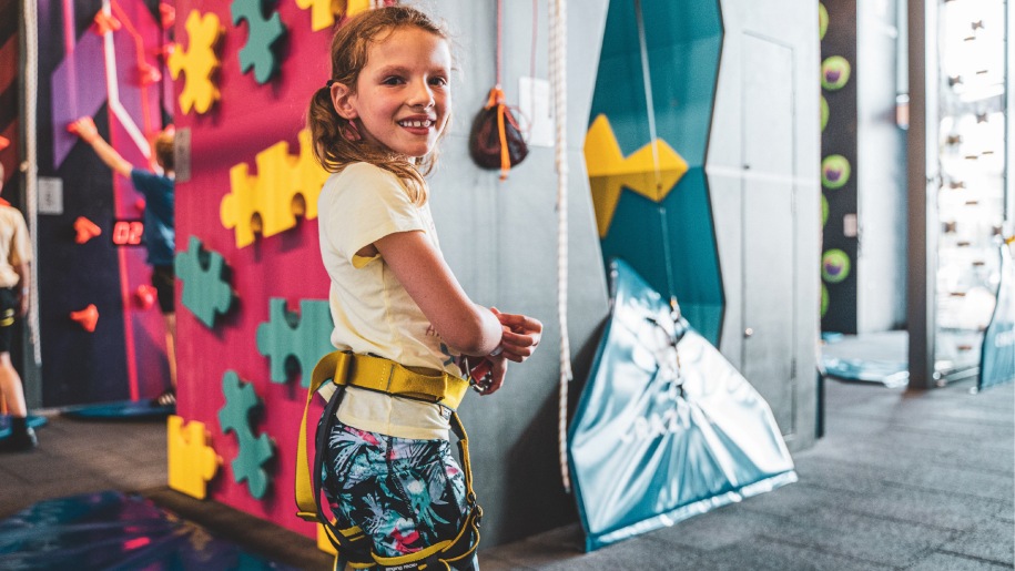 A child about to tackle a climbing wall at Crazy Climb Swansea.