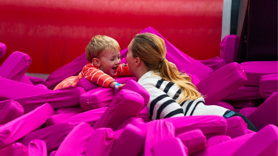 An adult and child playing in the foam pit at Freedog Bristol.