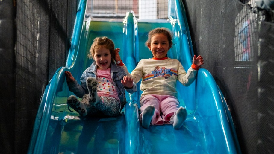 Children on a slide in the soft play area at Freedog Bristol.