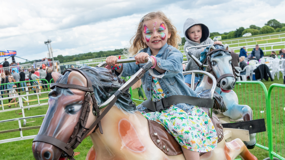 Kids on mechanical horses at Uttoxeter Racecourse's family raceday.