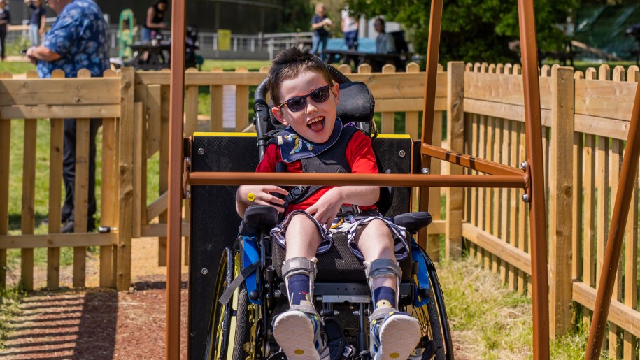 A child enjoying the wheelchair swing at Longdown Activity Farm.