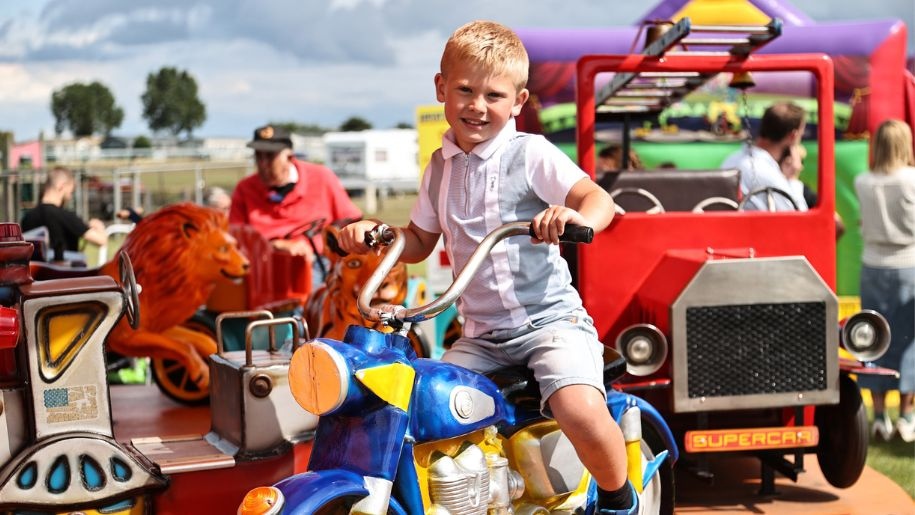 Child on a roundabout at Newcastle Racecourse.