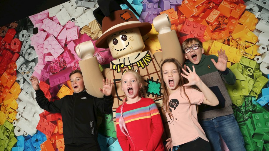 Children with Halloween scarecrow figure at LEGOLAND Discovery Centre.