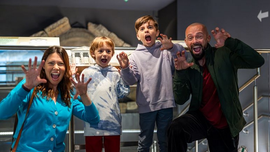 A family enjoying an event at the Roman Baths in Somerset.