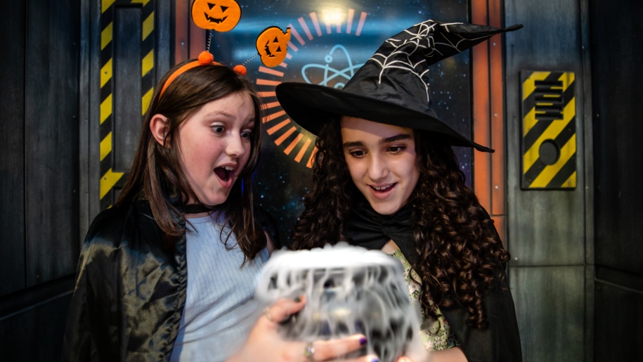 Witches looking at a bubbling potion at Winchester Science Centre.